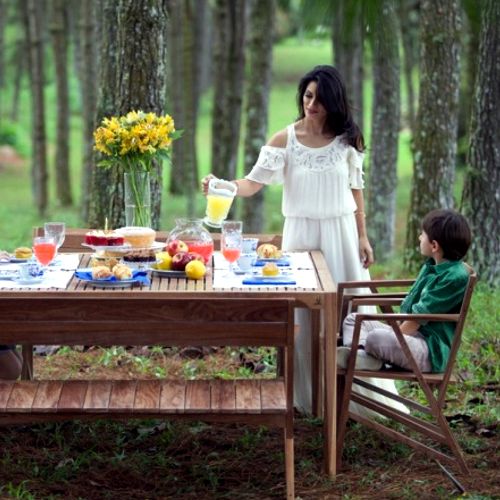 Comedor de madera para exterior modelo Atibaia para Butzke diseño de Paulo Alves y Luis Suzuki puesto en un jardin o bosque